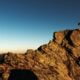 man standing on top of rock at daytime